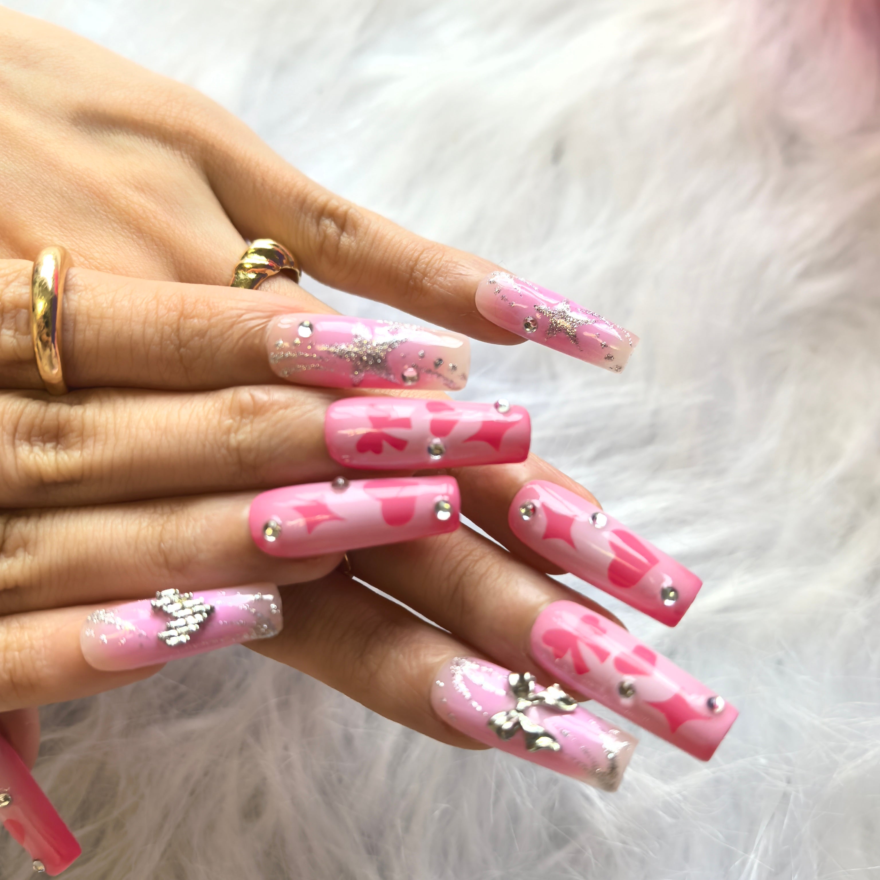 Candy Glitter coffin nails close-up – 3D silver bow charm and sparkling crystal heart on milky pink gradient