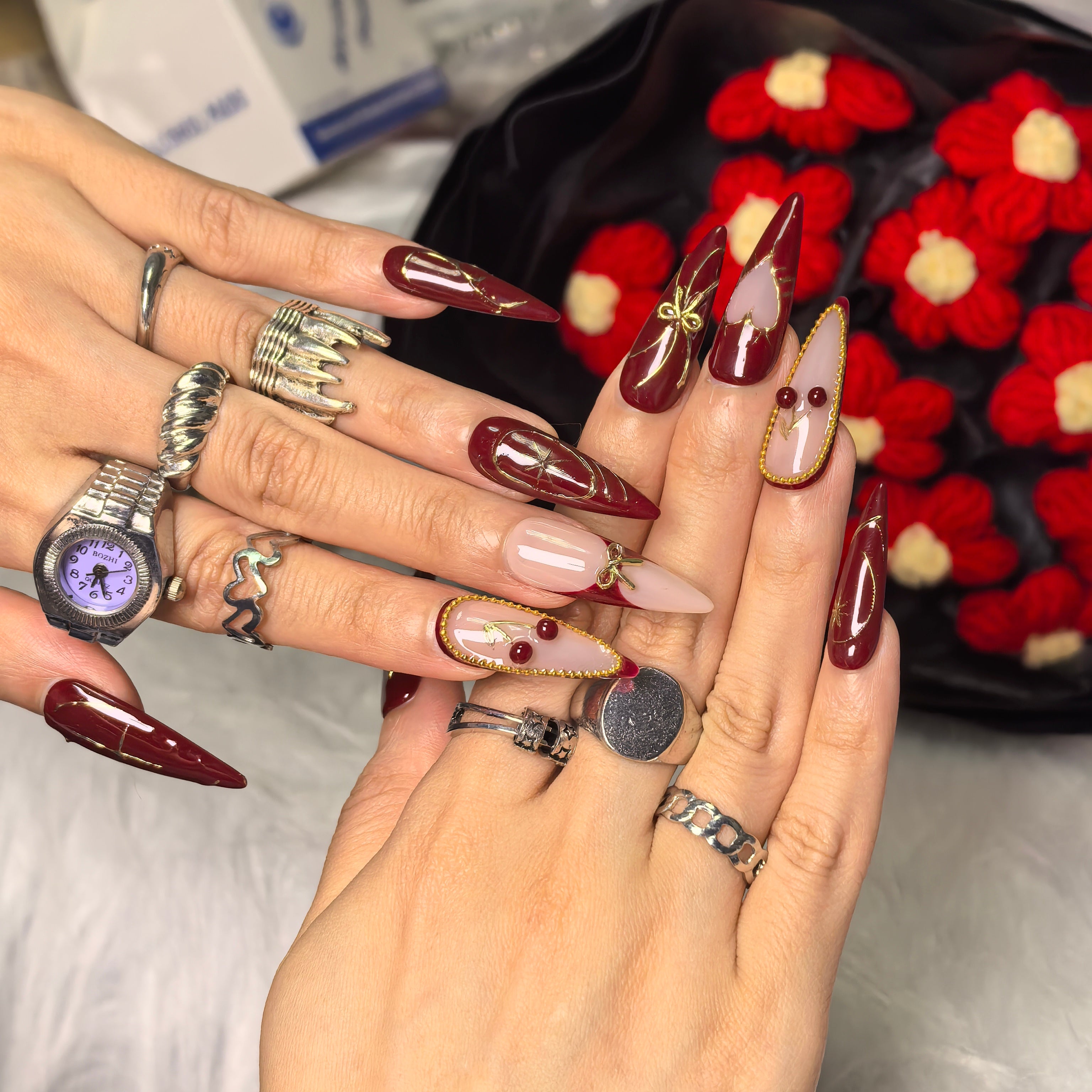 Cherry Bite press-on nails close-up – glossy 3D cherry charms with red bead stems on burgundy and nude French tip nails