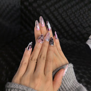 Close-up of Twilight Twist press-on nails — shattered silver chrome texture wine-red crackle pattern 3D metallic floral embellishment nail art by Poorguyshop