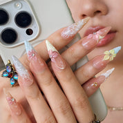 Floral press-on nails close-up – sparkling gemstone centers and star accents on pastel floral stiletto nails