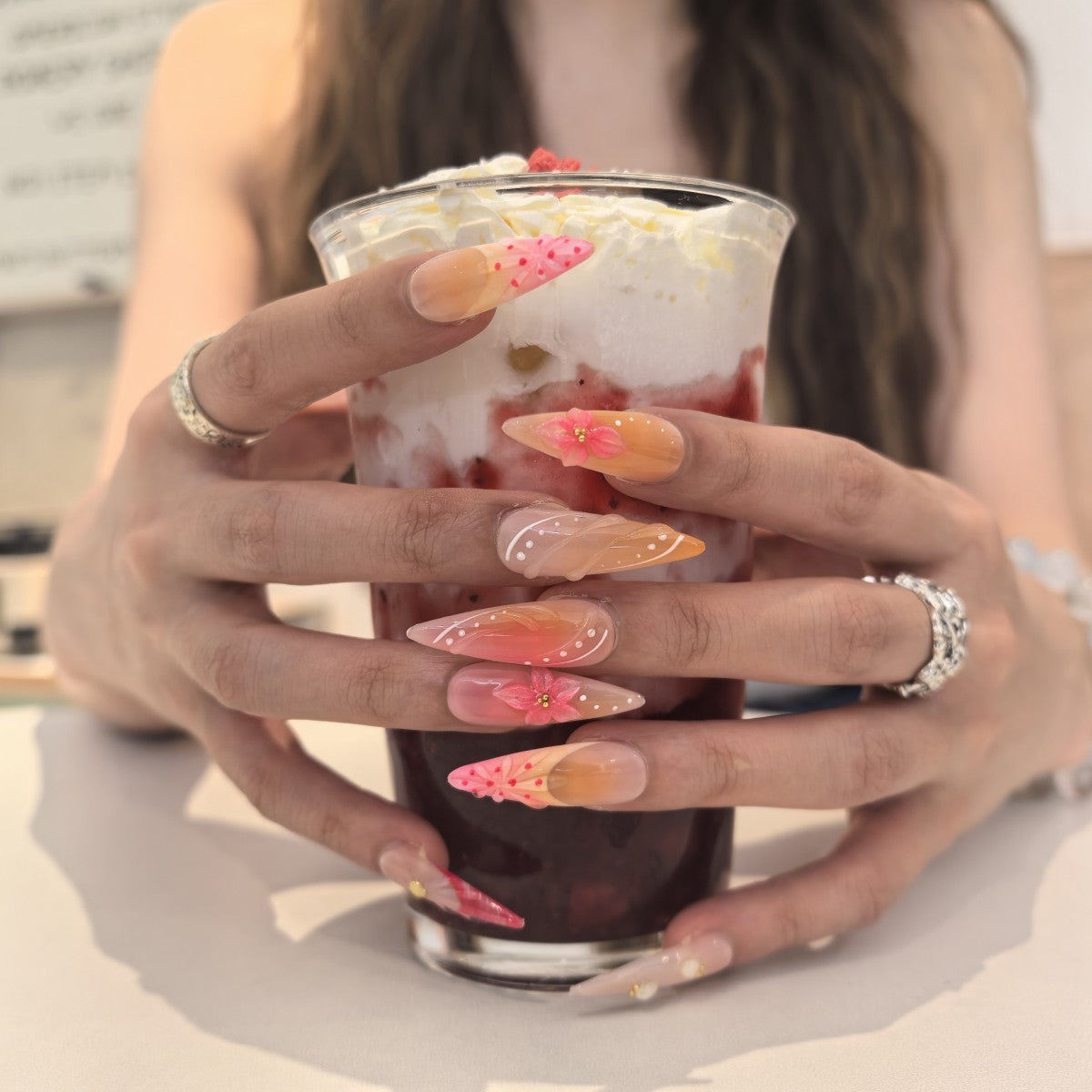 Samba Queen press-on nails close-up – pearl and gold accent embellishments on coastal beach stiletto nail art