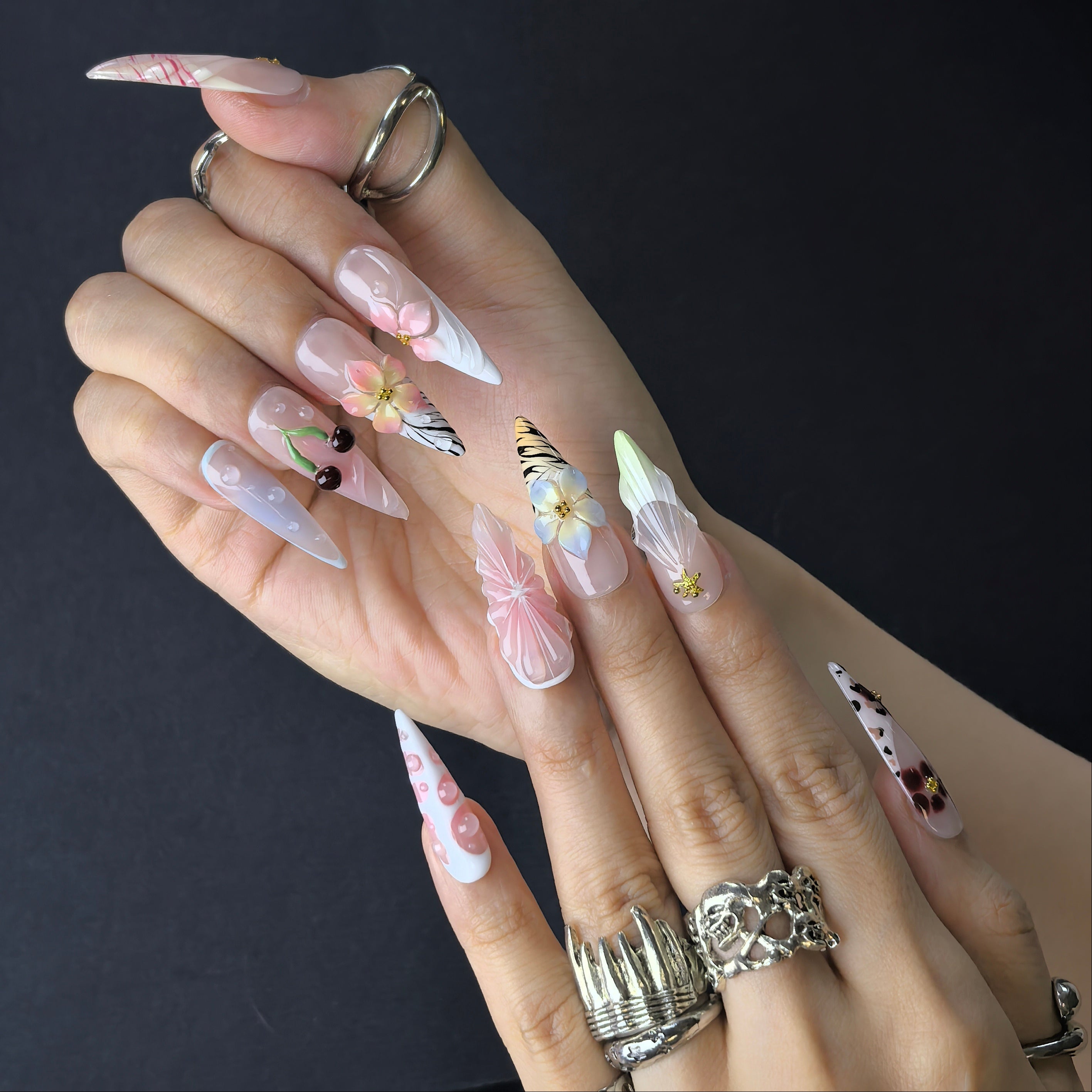 Woman wearing Blossom Picnic handmade press-on nails — cottagecore floral nail art coffin stiletto by Poorguyshop