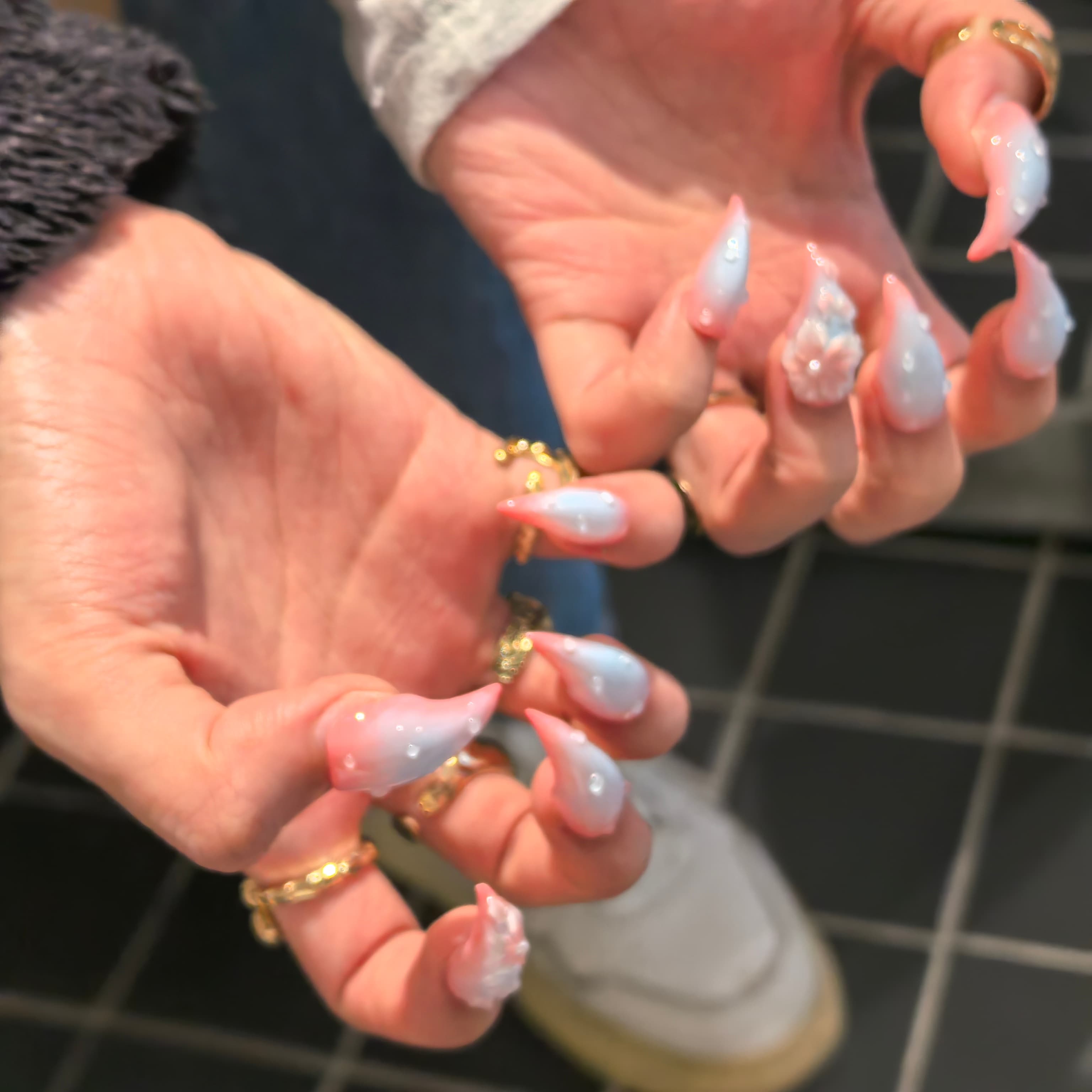 Woman wearing Cat Claws #1 handmade press-on nails — pink blue gradient floral pearl romantic nail art by Poorguyshop