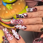 Woman wearing Dark Romanticism handmade press-on nails — marbled burgundy gothic cross pearl nail art square by Poorguyshop