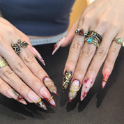 Woman wearing Lost Cherry handmade press-on nails — cherry blossom floral nail art coffin stiletto by Poorguyshop