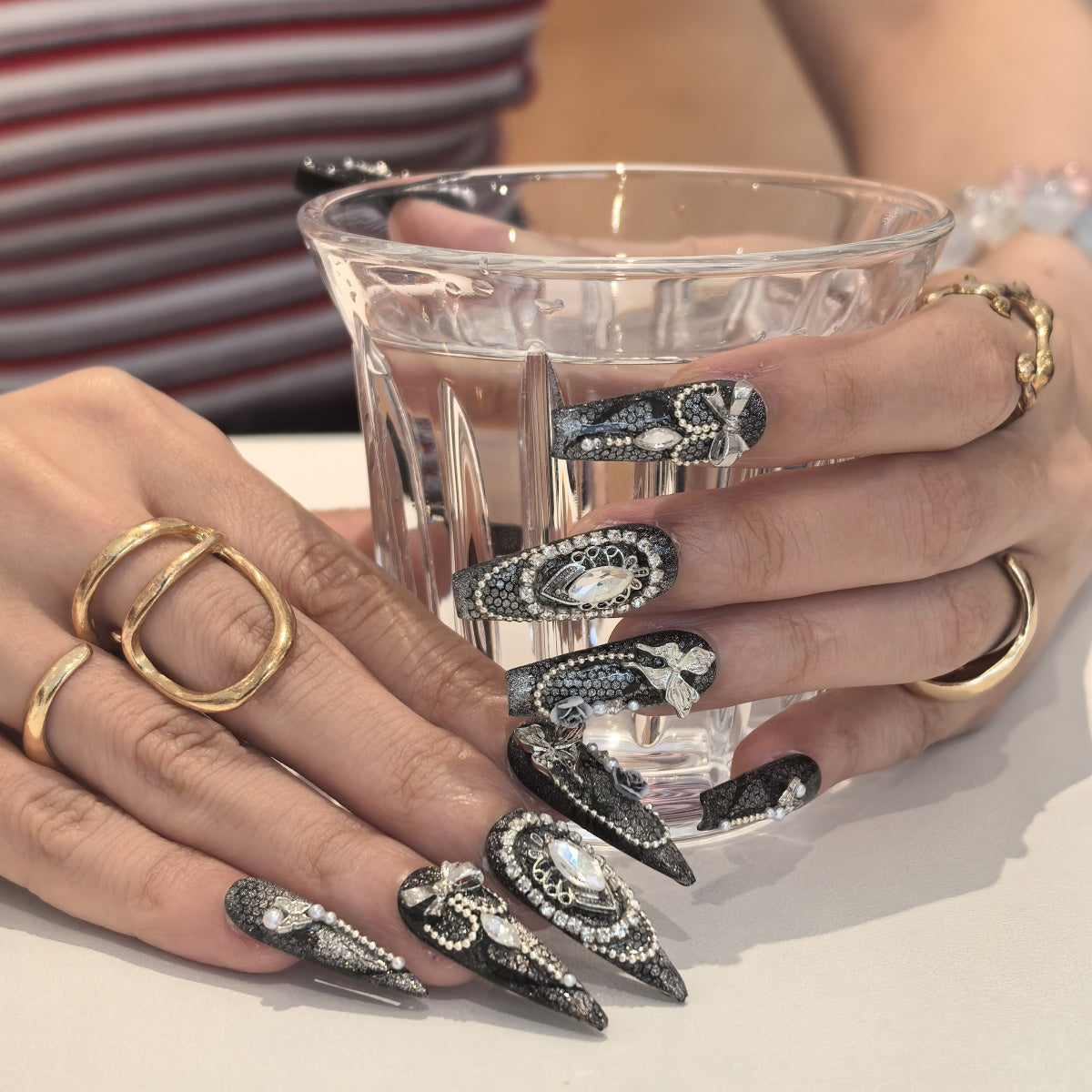 Woman wearing Pearlescence handmade press-on nails — pearl white iridescent nail art coffin stiletto by Poorguyshop