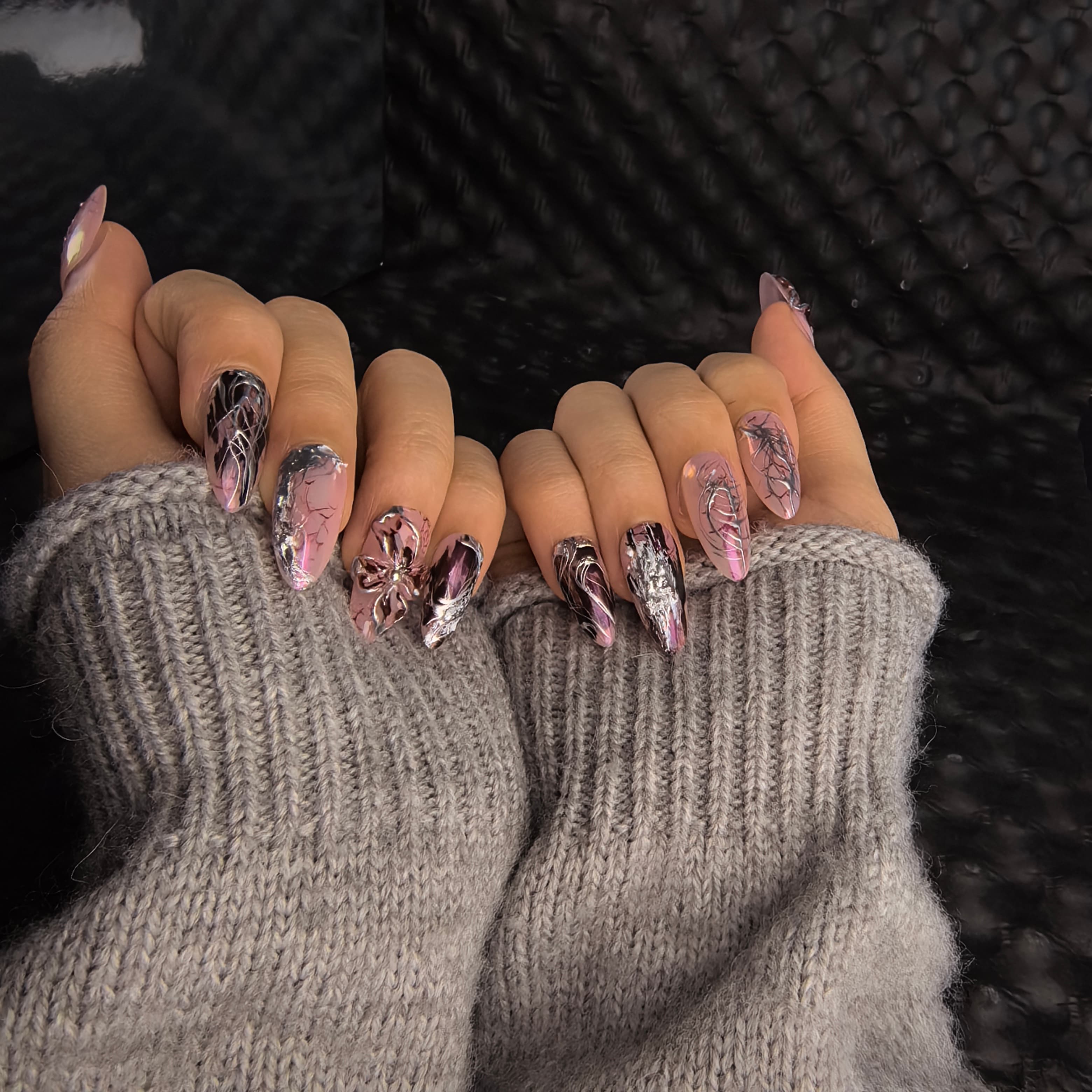 Woman wearing Twilight Twist handmade press-on nails — blush pink silver chrome wine crackle 3D floral nail art almond by Poorguyshop