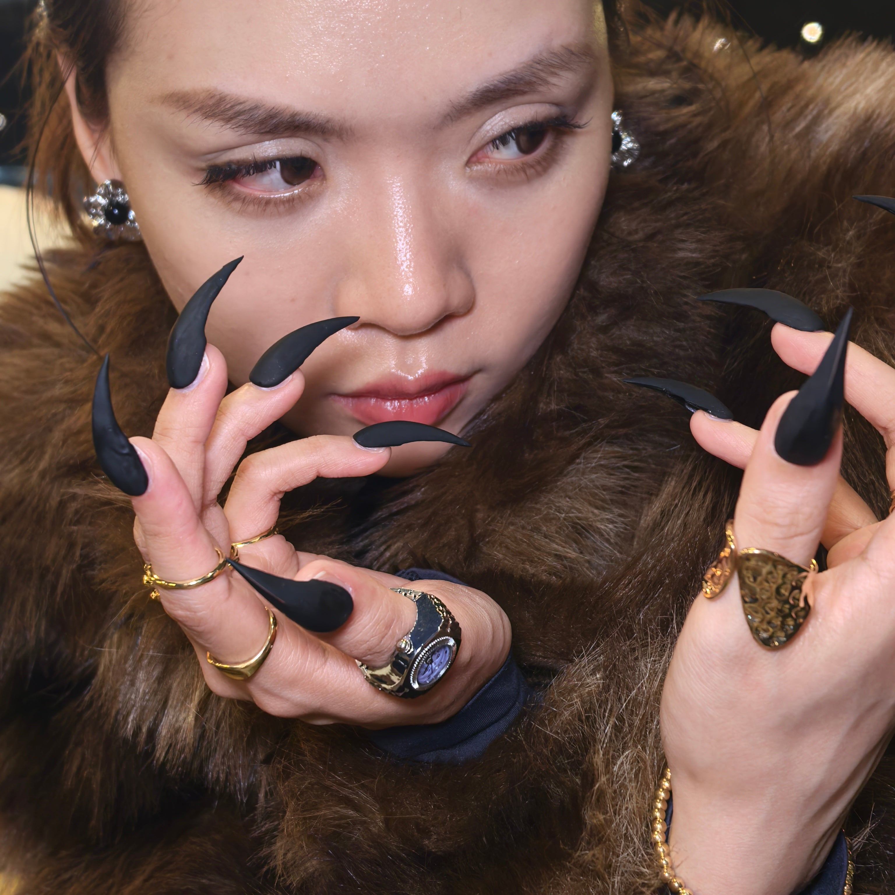 Close-up of Cat Claw #4 press-on nails — sleek all-black high-gloss claw shape nail art by Poorguyshop